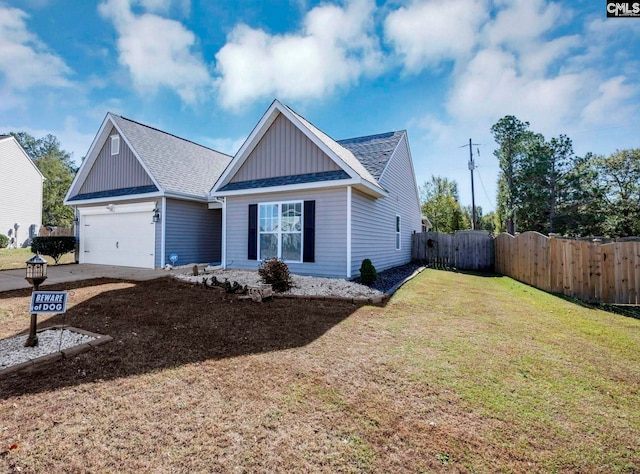 view of front of property featuring a garage and a front yard