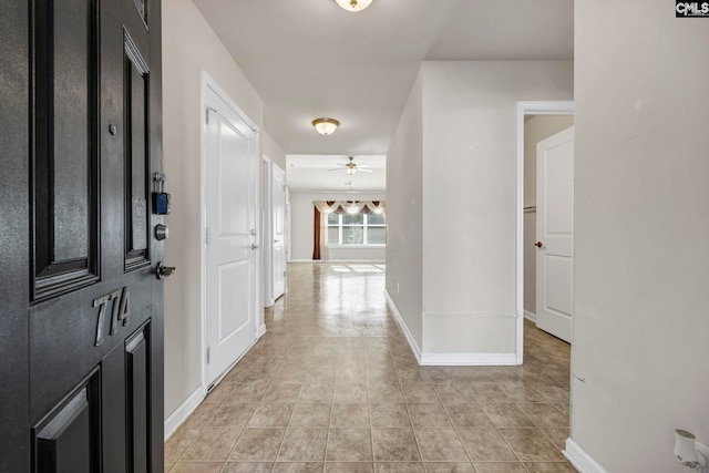 corridor with light tile patterned flooring