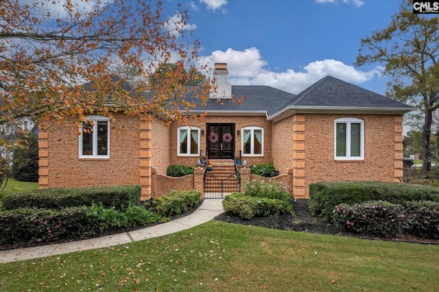 view of front of house featuring french doors and a front lawn