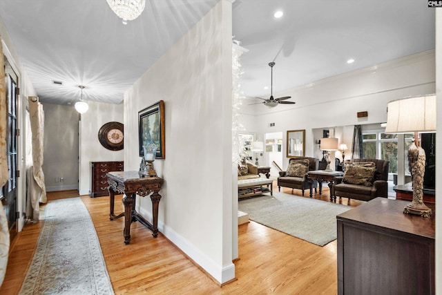 corridor featuring light hardwood / wood-style floors and crown molding