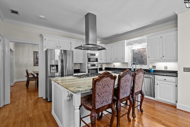 kitchen featuring light hardwood / wood-style floors, white cabinetry, island exhaust hood, and stainless steel appliances