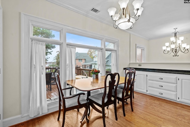 dining space featuring a notable chandelier, light wood-type flooring, and a wealth of natural light