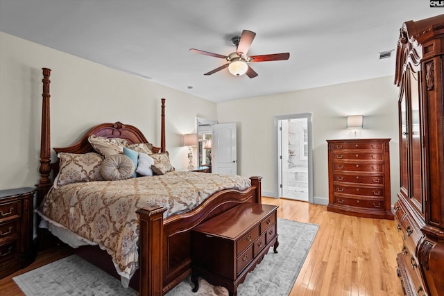 bedroom with ensuite bathroom, ceiling fan, and light hardwood / wood-style flooring