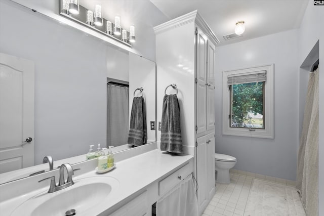 bathroom with tile patterned flooring, vanity, and toilet