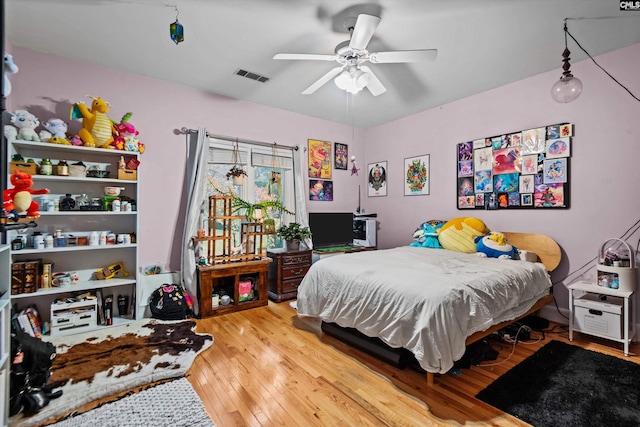 bedroom with wood-type flooring and ceiling fan