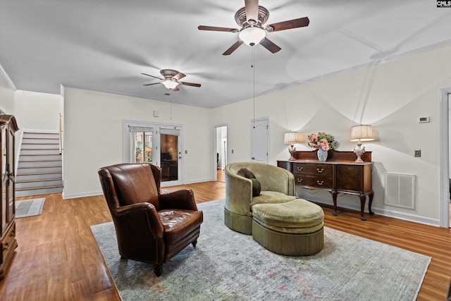 living room featuring hardwood / wood-style floors, french doors, and ceiling fan