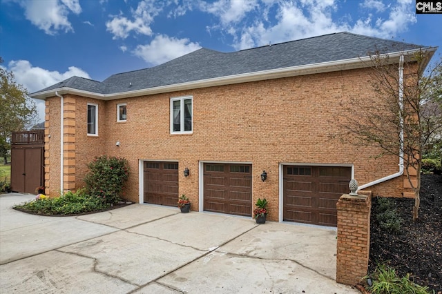 rear view of house featuring a garage