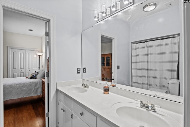 bathroom featuring hardwood / wood-style floors, vanity, and a shower with curtain