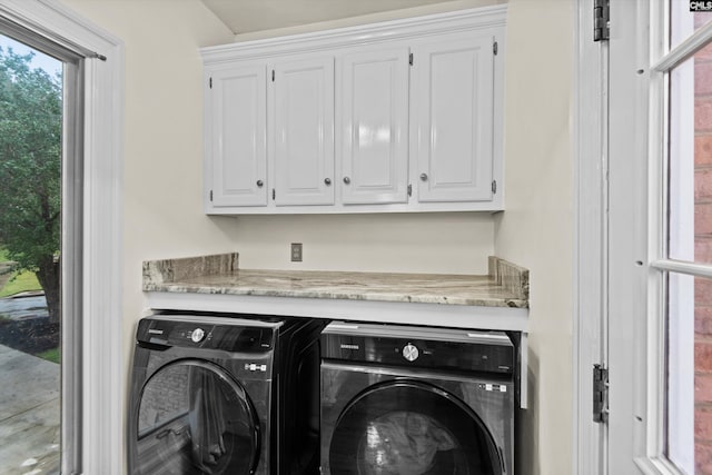 laundry room with cabinets and separate washer and dryer