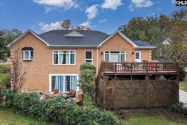 rear view of house featuring a wooden deck and an outdoor hangout area