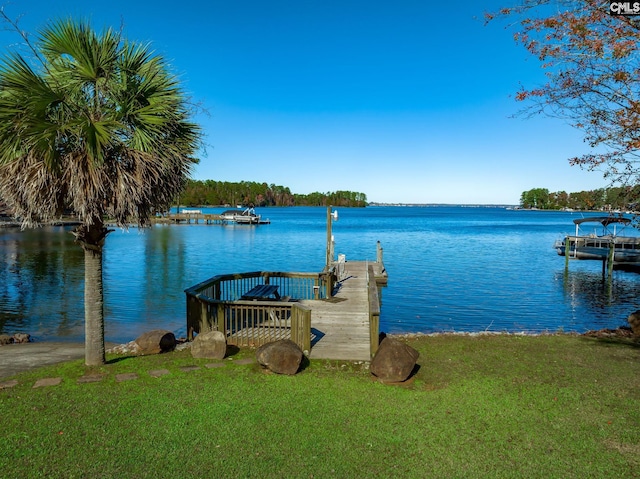 dock area featuring a water view and a lawn