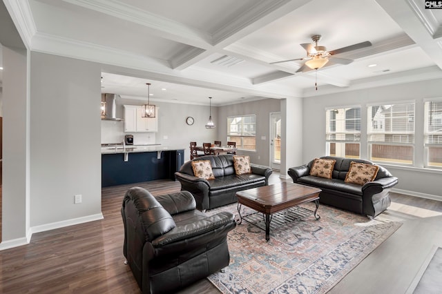 living room with coffered ceiling, hardwood / wood-style flooring, ceiling fan, ornamental molding, and beam ceiling