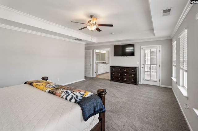 carpeted bedroom with crown molding, ensuite bath, ceiling fan, access to exterior, and a tray ceiling