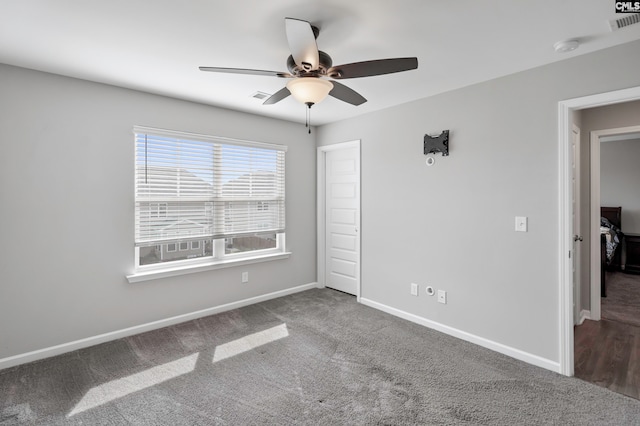 unfurnished bedroom featuring ceiling fan and carpet floors