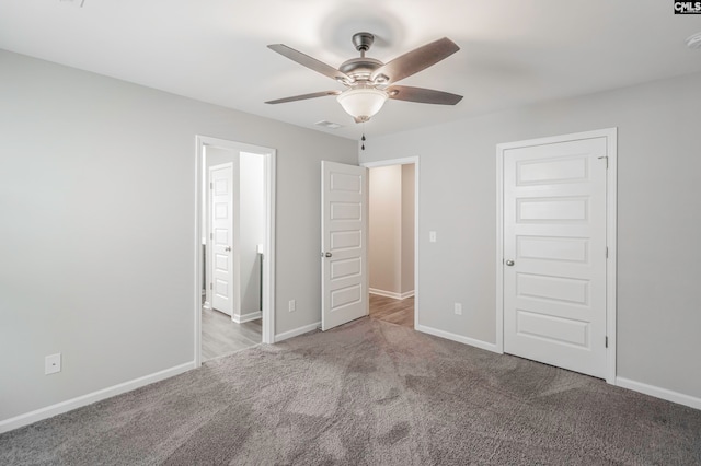 unfurnished bedroom featuring light carpet and ceiling fan