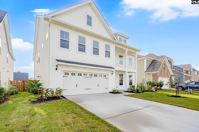 view of front of house featuring a garage, a balcony, and a front lawn