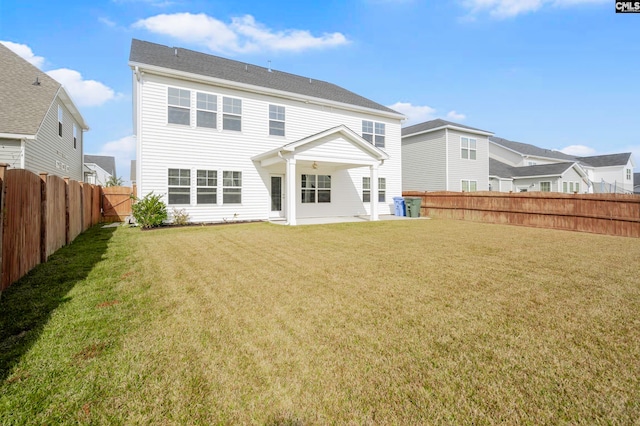 back of house featuring a yard