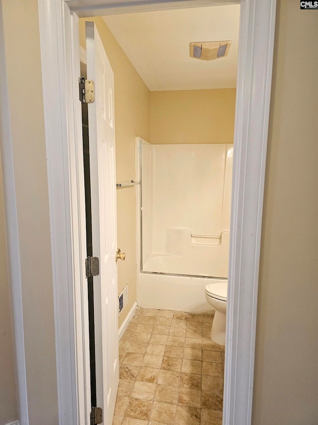 bathroom featuring bathing tub / shower combination and toilet