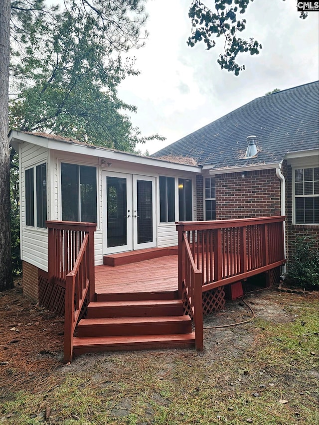 rear view of property featuring french doors and a deck