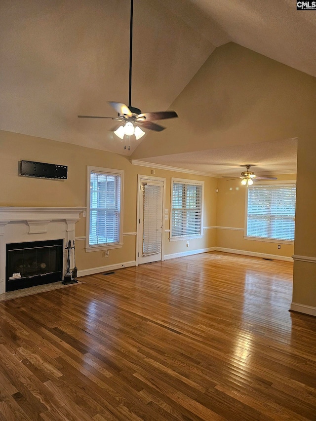 unfurnished living room with a textured ceiling, hardwood / wood-style floors, and lofted ceiling