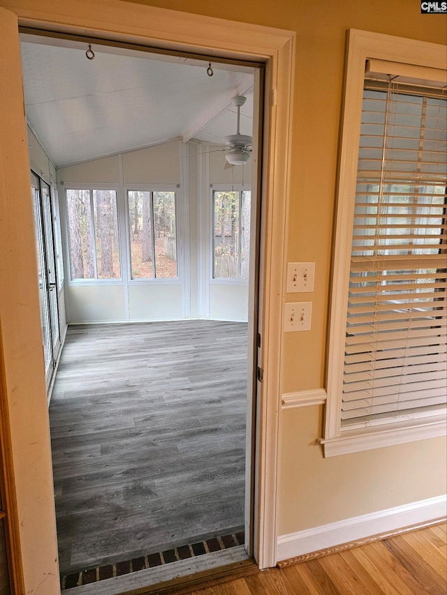 interior space with ceiling fan and vaulted ceiling