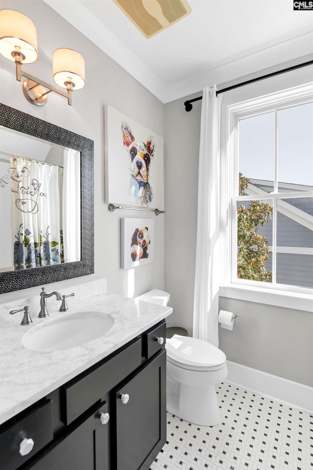 bathroom featuring tile patterned floors, vanity, and toilet