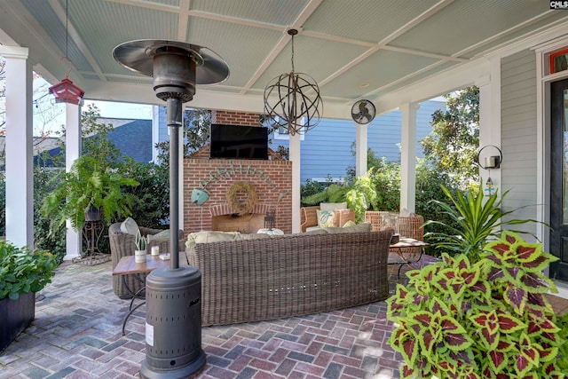 view of patio with an outdoor living space with a fireplace