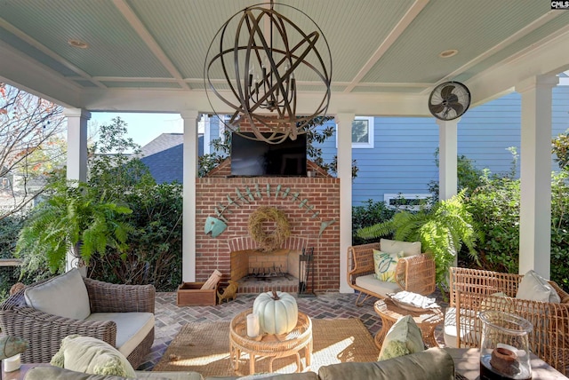 view of patio with an outdoor living space with a fireplace