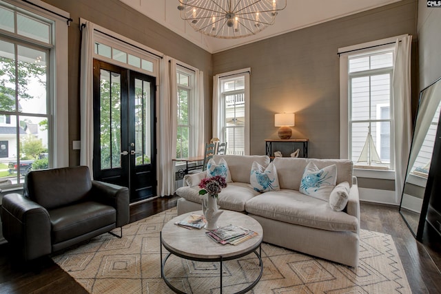 living room featuring a notable chandelier, dark hardwood / wood-style floors, and plenty of natural light