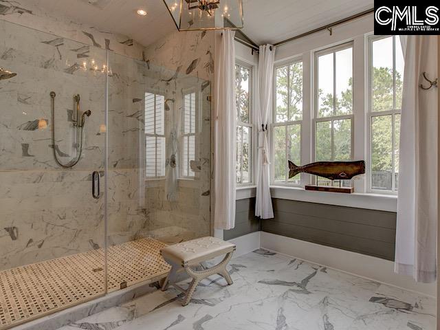 bathroom featuring a shower with shower door