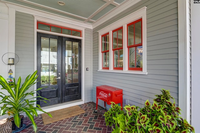 view of exterior entry with french doors and covered porch