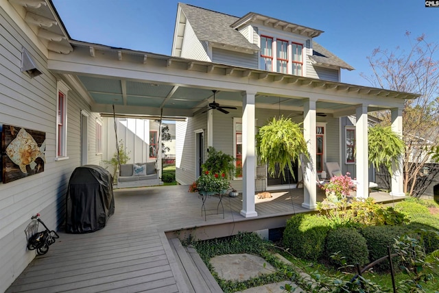 wooden terrace featuring ceiling fan and area for grilling