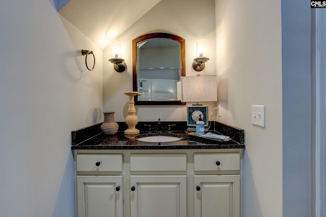 bathroom featuring vanity and vaulted ceiling