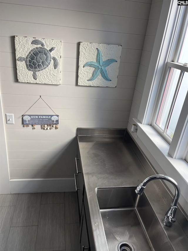 details featuring wood walls and sink