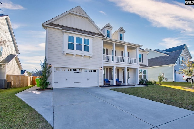 view of front of home featuring central AC, a balcony, a front yard, and a garage