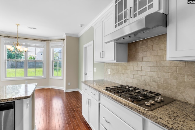 kitchen featuring light stone countertops, dark hardwood / wood-style floors, stainless steel gas stovetop, white cabinets, and ornamental molding