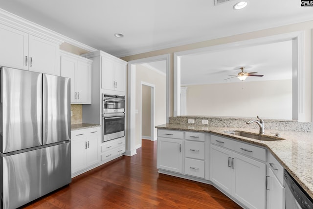 kitchen featuring stainless steel appliances, white cabinetry, and sink