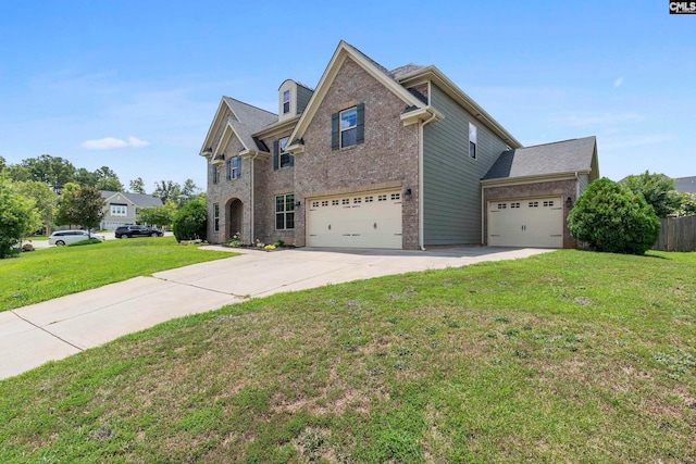 view of property featuring a garage and a front lawn