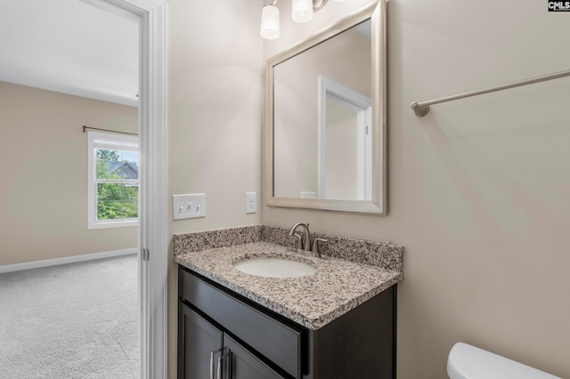 bathroom featuring vanity and toilet