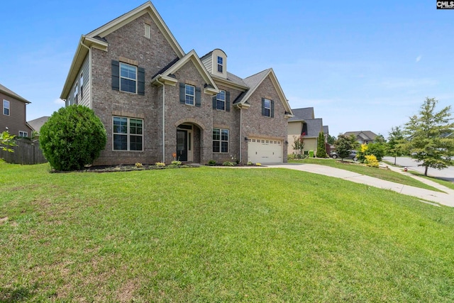 view of front of house with a garage and a front lawn