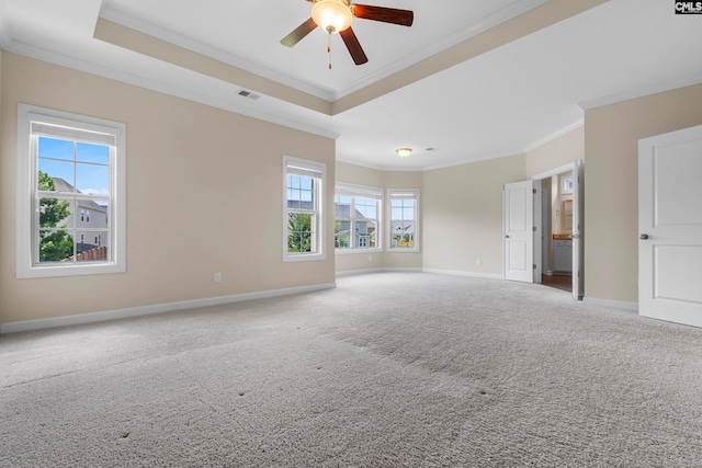 unfurnished room with ceiling fan, ornamental molding, carpet floors, and a tray ceiling