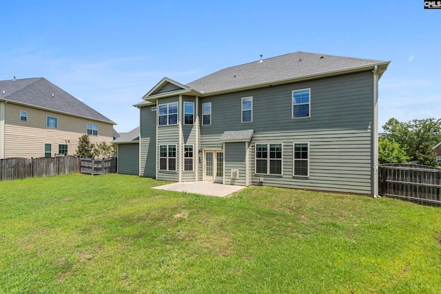 rear view of house with a patio area and a lawn