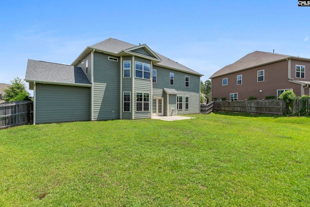 back of property with a patio and a lawn