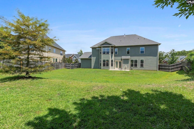 back of property featuring a lawn