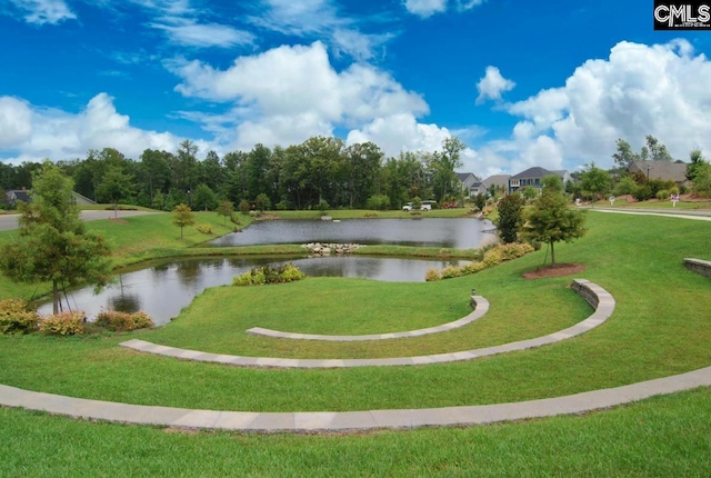 view of home's community with a yard and a water view