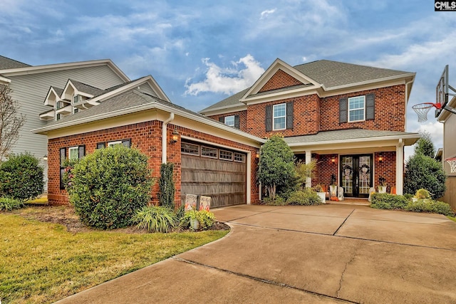 craftsman inspired home with a front yard, french doors, and a garage