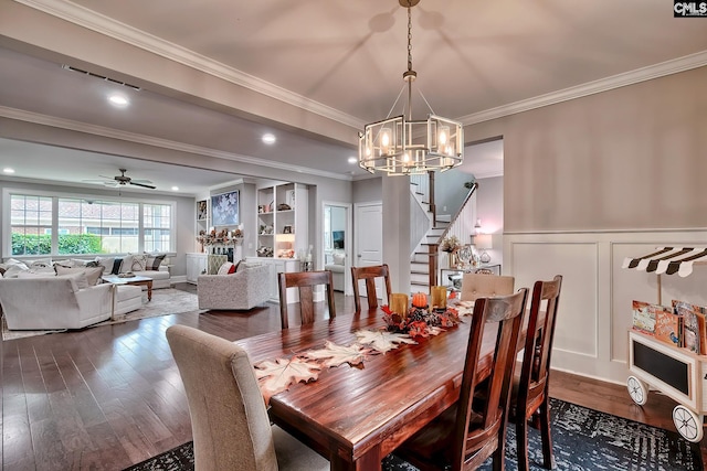 dining room featuring ceiling fan with notable chandelier, hardwood / wood-style flooring, and ornamental molding