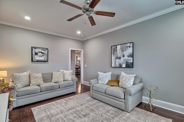 living room featuring ceiling fan, dark hardwood / wood-style flooring, and ornamental molding