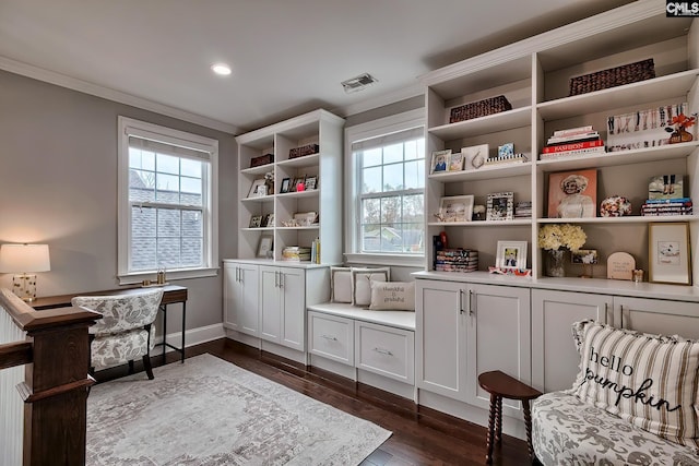 sitting room featuring crown molding and dark wood-type flooring