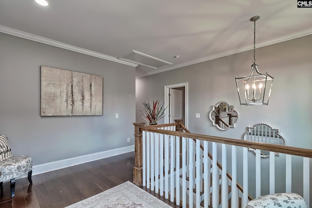 corridor featuring dark hardwood / wood-style floors, crown molding, and a notable chandelier